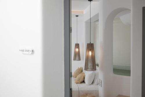 a room with two lamps sitting on a couch at Majestique of Naxos in Naxos Chora