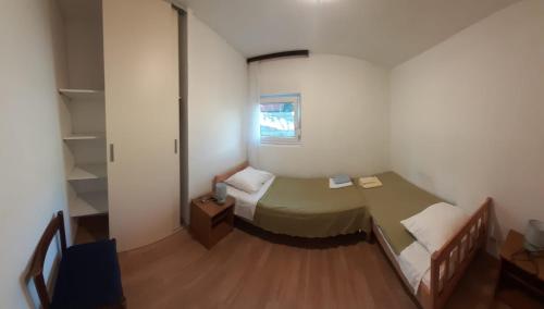 a small room with a bed and a couch at Apartments Marija in Krk