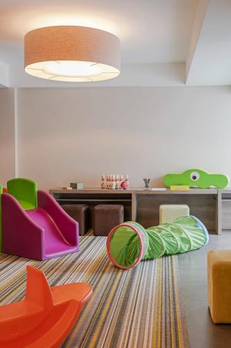 a living room with colorful chairs and a rug at Terra Nostra Garden Hotel in Furnas