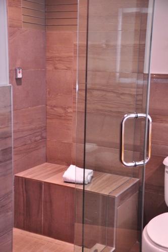 a shower with a glass door and a toilet at Hotel 11, MOD A Sonesta Collection in Calgary