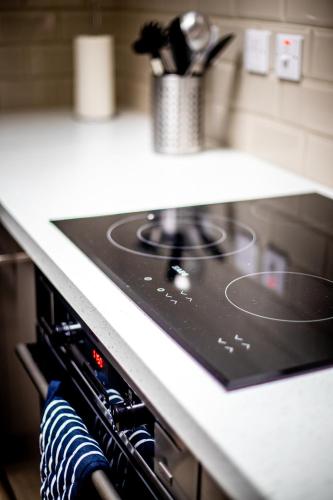 a stove top oven sitting in a kitchen at Sail Lofts in Douglas