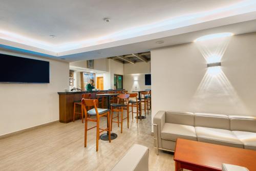 a living room with a couch and a bar at Kibo Palace Hotel Moshi in Moshi