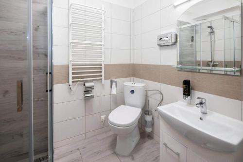 a bathroom with a toilet and a sink and a shower at Penzion Zuzana in Ružomberok
