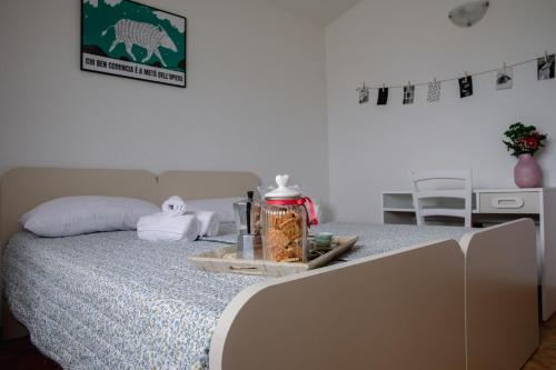 a bedroom with a bed with a tray on it at Residenze Pedrame in Budoni