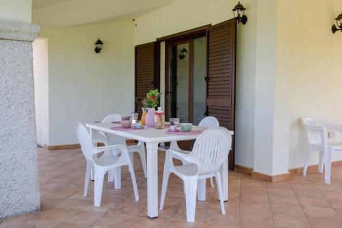 a white table and chairs on a patio at Residenze Pedrame in Budoni