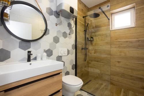 W łazience znajduje się toaleta, umywalka i lustro. w obiekcie Luxury Apartments Love w mieście Kaštela