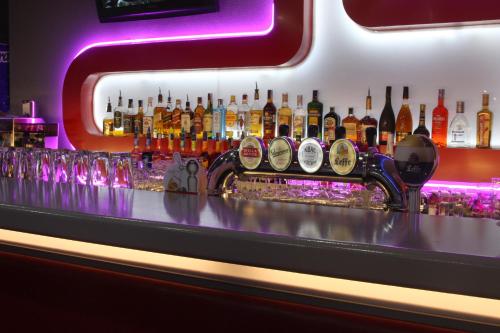 a bar with a lot of bottles of alcohol at Hotel Praha in Uzhhorod