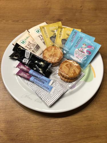 a white plate with food and snacks on a table at Très bel appartement vue mer avec piscine in Douarnenez