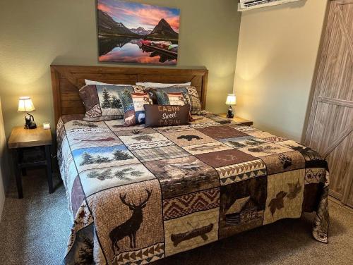 a bedroom with a bed with a quilt on it at 2 Bedroom Cabin Inside Glacier National Park in West Glacier