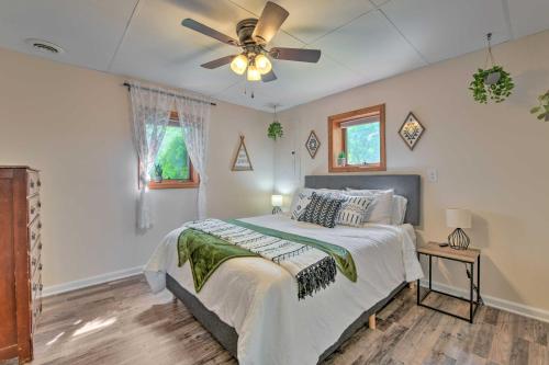 a bedroom with a bed and a ceiling fan at Pet-Friendly Waynesville Home with Mountain Views! in Waynesville