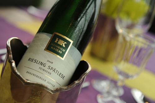 a bottle of wine in a holder on a table at Winzerstübchen in Brauneberg