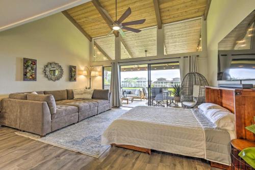 a living room with a bed and a couch at Chic Waikoloa Condo with Lanai and Complex Pools! in Waikoloa