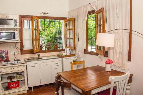 a kitchen with a wooden table and a kitchen with a sink at Casita de limon in Godoy Cruz