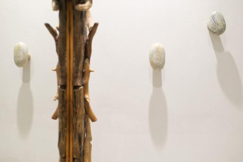 a piece of wood with three objects on a wall at Majestique of Naxos in Naxos Chora