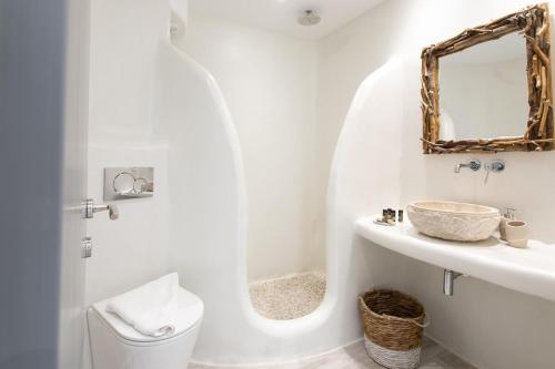 a white bathroom with a sink and a mirror at Majestique of Naxos in Naxos Chora