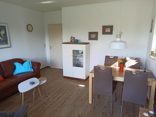 a living room with a couch and a table at Ferienhaus D51 Europa Feriendorf 2-5 Personen in Lichtenau