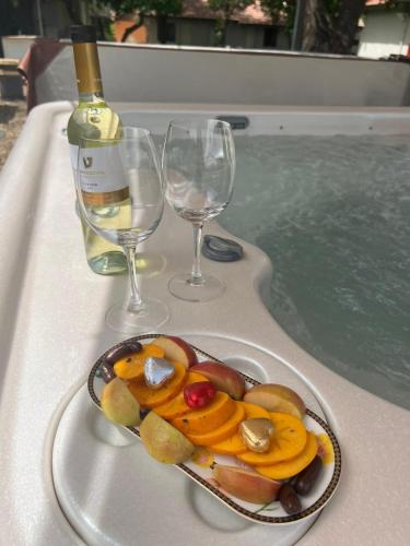 a plate of food on a tray next to two wine glasses at אחוזת המייסדים in Bet Hillel