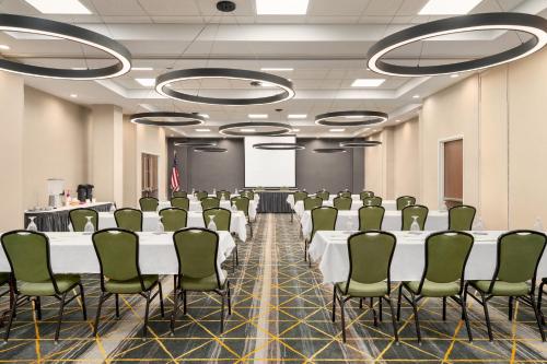 a conference room with rows of tables and chairs at Holiday Inn Florence by IHG in Florence