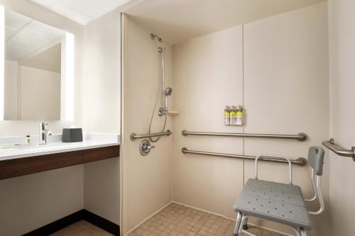 a bathroom with a sink and a chair at Holiday Inn Florence by IHG in Florence