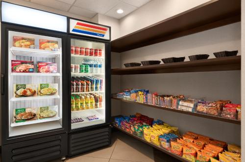 a refrigerator filled with lots of food and drinks at Holiday Inn Florence, an IHG Hotel in Florence