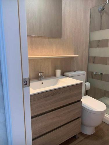 a bathroom with a sink and a toilet at Bungalow Green Oasis 1010 in Maspalomas