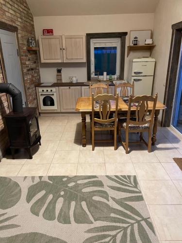 a kitchen with a table and chairs and a stove at ALANTOS ŽIRGAI Holiday Villas sauna or hottube additional price in Alanta