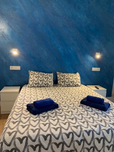 a bedroom with a bed with two pillows on it at Bungalow Green Oasis 1010 in Maspalomas