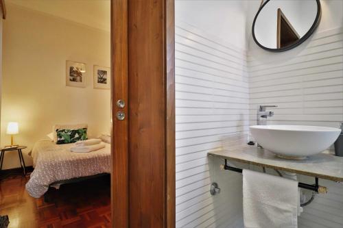 ein Badezimmer mit Waschbecken und Bett in der Unterkunft Costa Norte Guesthouse in Ribeira Grande