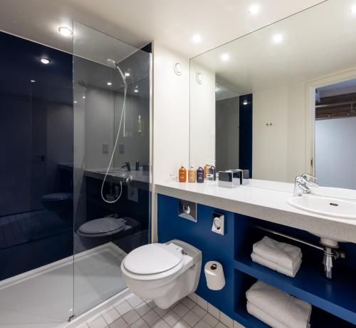 a bathroom with a toilet, sink, and shower at Holiday Inn York City Centre, an IHG Hotel in York
