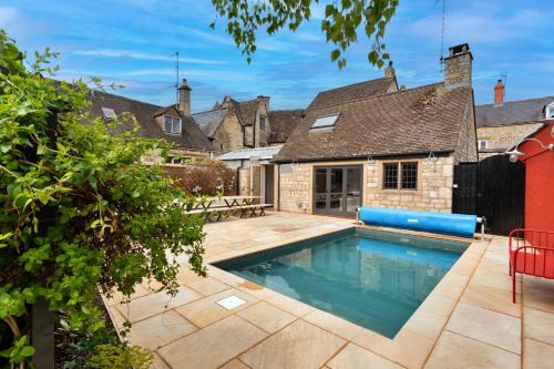 a swimming pool in the backyard of a house at Finest Retreats - ARC Painswick in Painswick