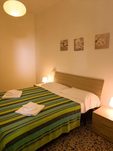 a bedroom with a bed and two towels on it at Classic Monterossino Apartment in Old Town in Monterosso al Mare