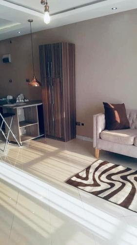 a living room with a couch and a table at Trendy apartments in Entebbe