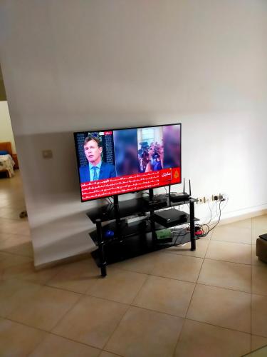 a flat screen tv sitting on a stand in a living room at Residence tafoult ri imiouaddar in Imi Ouaddar
