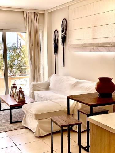a living room with a couch and a table at PH Marina Apartments in Porto Heli