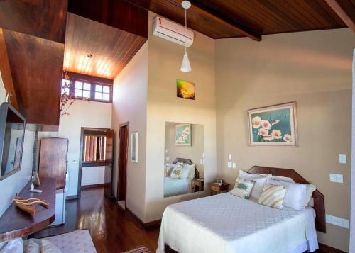 a bedroom with a bed in a room at Oceanica 1000 Beachfront Suites in Saquarema