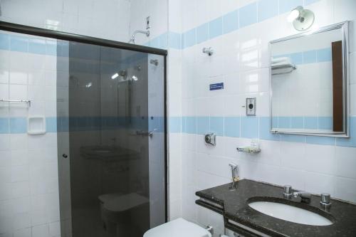 a bathroom with a shower and a sink and a toilet at SESC ARAXÁ in Araxá