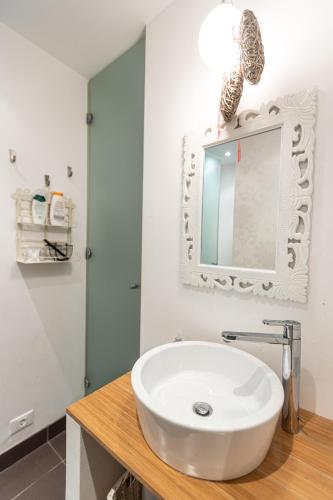 a bathroom with a white sink and a mirror at Piran Holiday Apartments in the city center in Piran