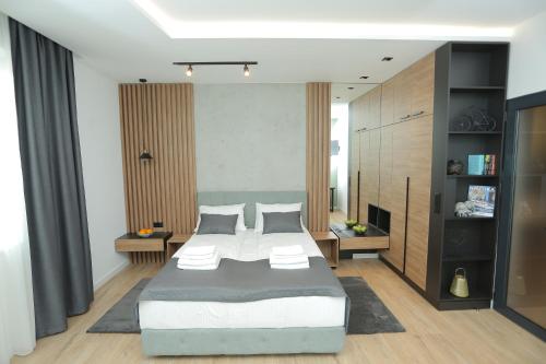 a bedroom with a large bed in a room at Bonanza Apartments in Niš