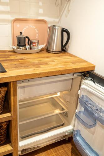 a kitchen with a counter top on top of an open refrigerator at Piran Holiday Apartments in the city center in Piran