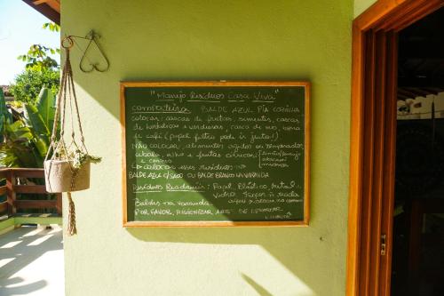 a chalkboard sign on the wall of a restaurant at Casa Viva Itamambuca in Ubatuba