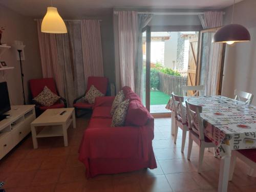 a living room with a table and a dining room at Pico Argualas in Villanúa
