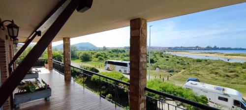 a balcony with a view of the river at Apartamento Tomela in Noja