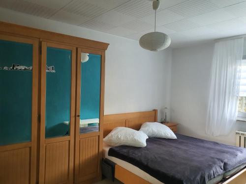 a bedroom with a bed and a glass cabinet at " Die Wolfs Burg" 50qm & zentrumsnah in Wolfsburg
