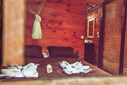 a bedroom with a bed with towels on it at Raiz Kite Cabana in Jericoacoara