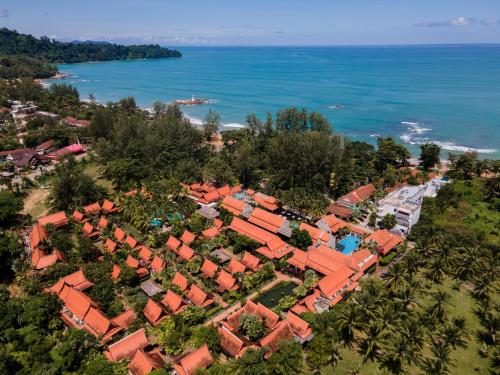 an aerial view of a village next to the ocean at Khaolak Bhandari Resort & Spa in Khao Lak