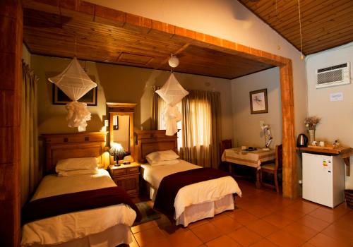 A bed or beds in a room at Sunbird Lodge