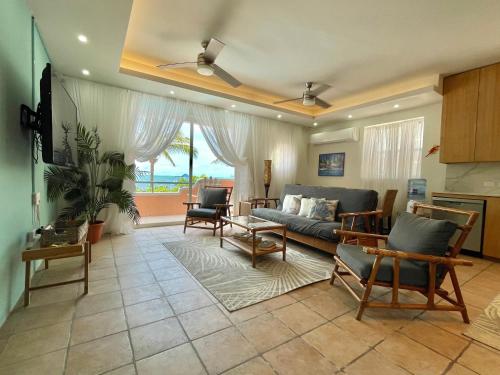 a living room with a couch and a table at Seaside Villas in Caye Caulker