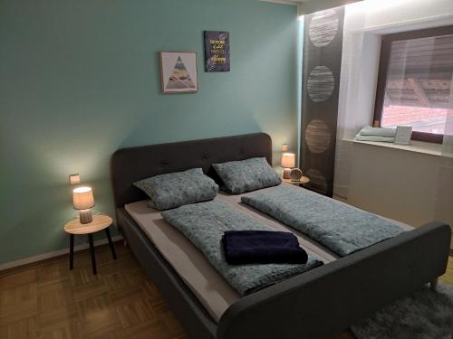a bed in a room with two pillows on it at Maison Mellie in Oberhausen