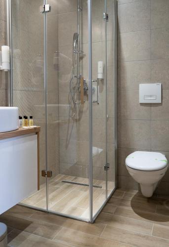 a shower stall in a bathroom with a toilet at HA Hotel Mostar in Mostar