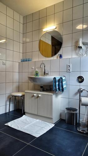 a bathroom with a sink and a mirror at Ferienhaus Wellisch in Lohberg
